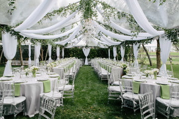 Floral tent decoration makes the wedding venue look blissful.