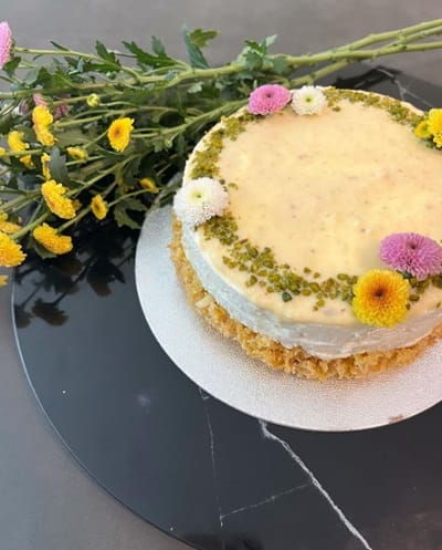 The crunchy texture of Ghevar, topped with Rabri and paired with a creamy cheesecake layer, creates a unique blend of flavors.