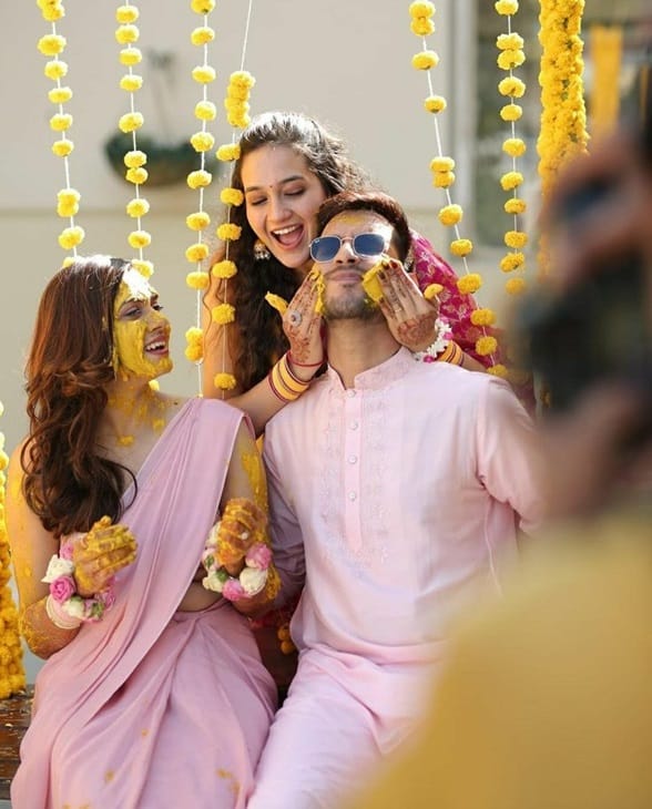 The baby pink coordinating Haldi outfits are cute. 