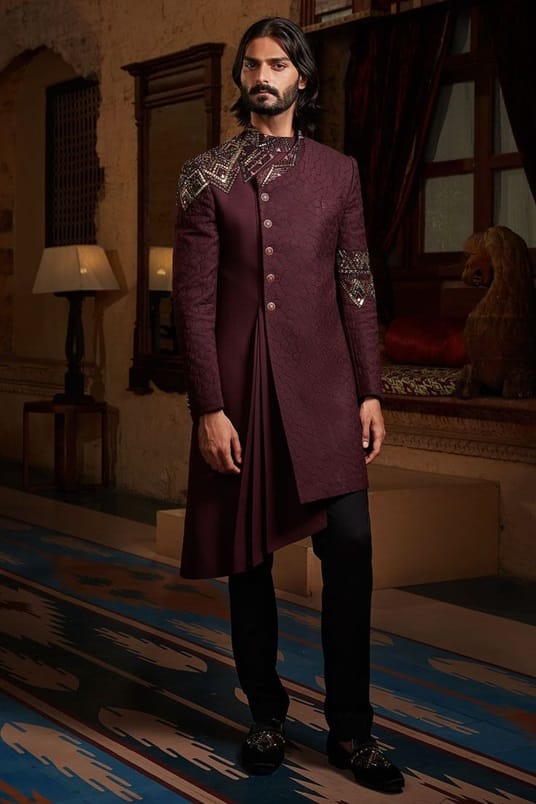 A wine-red kurta or a Jodhpuri suit with intricate gold details will be perfect for your wedding reception